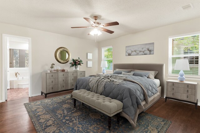 bedroom with ceiling fan, dark hardwood / wood-style flooring, and multiple windows