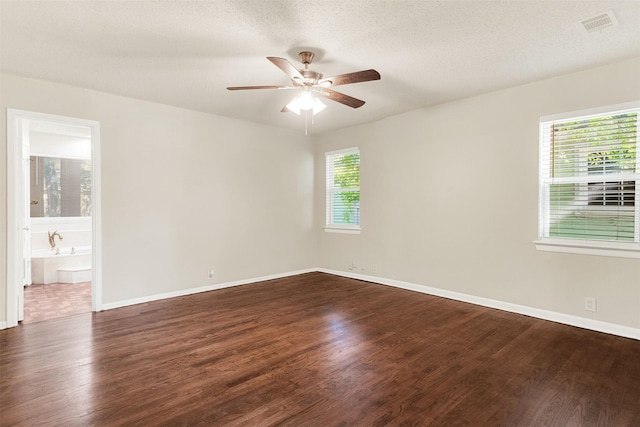 1725 Brake Dr, Carrollton, TX 75006 - empty room featuring dark wood-style flooring, ceiling fan, and a textured ceiling