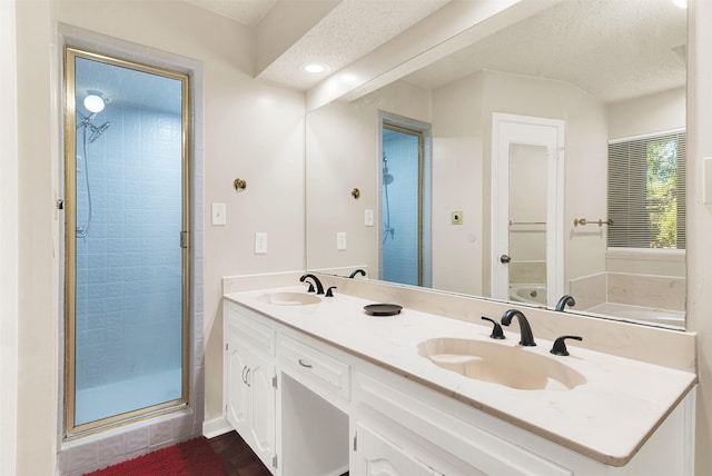 1725 Brake Dr, Carrollton, TX 75006 - full bathroom featuring double vanity, a stall shower, recessed lighting, and a textured ceiling