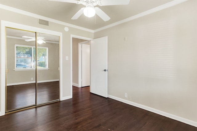 unfurnished bedroom with dark hardwood / wood-style flooring, a closet, ornamental molding, and ceiling fan