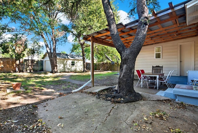 1725 Brake Dr, Carrollton, TX 75006 - fenced backyard featuring a patio area and an outbuilding