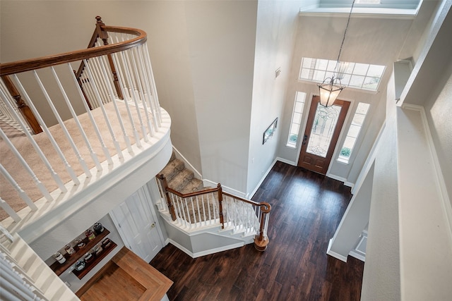 foyer entrance featuring dark hardwood / wood-style flooring and an inviting chandelier