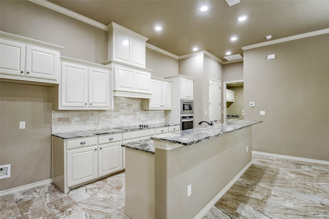 kitchen with white cabinets, appliances with stainless steel finishes, stone countertops, and tasteful backsplash