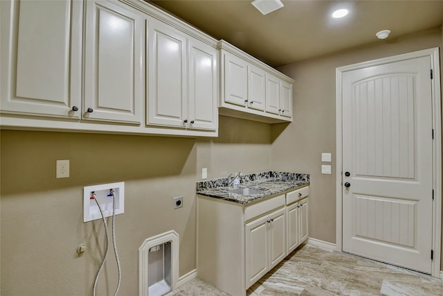 laundry room featuring electric dryer hookup, cabinets, sink, and hookup for a washing machine