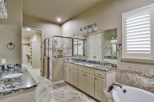 bathroom with vanity and independent shower and bath