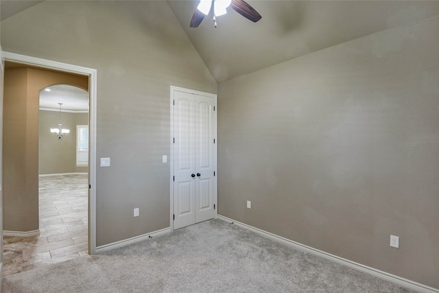 unfurnished bedroom featuring light carpet, a closet, high vaulted ceiling, and ceiling fan