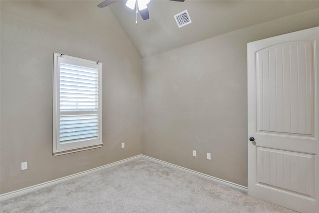 carpeted empty room with ceiling fan and lofted ceiling