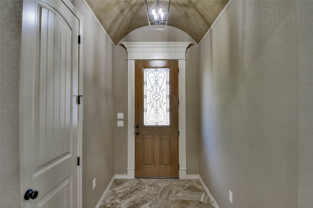 doorway to outside with vaulted ceiling and an inviting chandelier