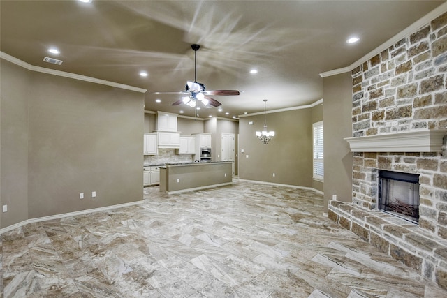 unfurnished living room featuring a fireplace, crown molding, and ceiling fan with notable chandelier