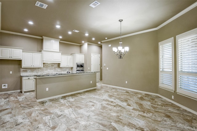 kitchen with white cabinetry, crown molding, and a kitchen island with sink