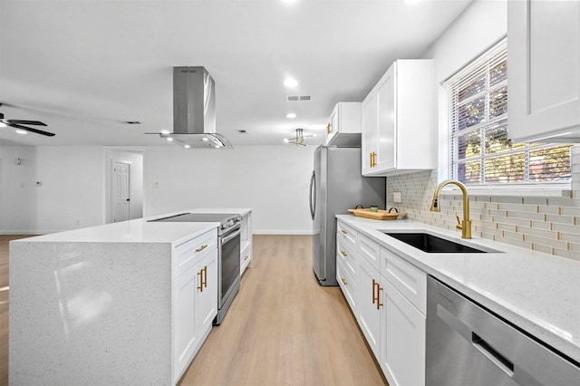 kitchen with stainless steel appliances, extractor fan, sink, and white cabinetry