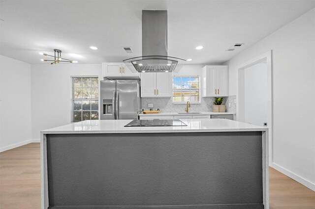 kitchen featuring white cabinetry, island exhaust hood, a large island, and stainless steel fridge with ice dispenser