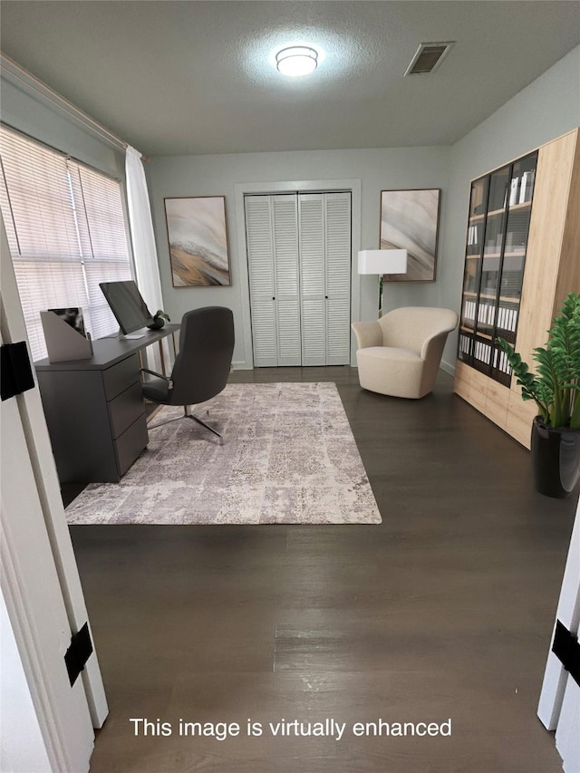 office area with dark wood-type flooring and a textured ceiling