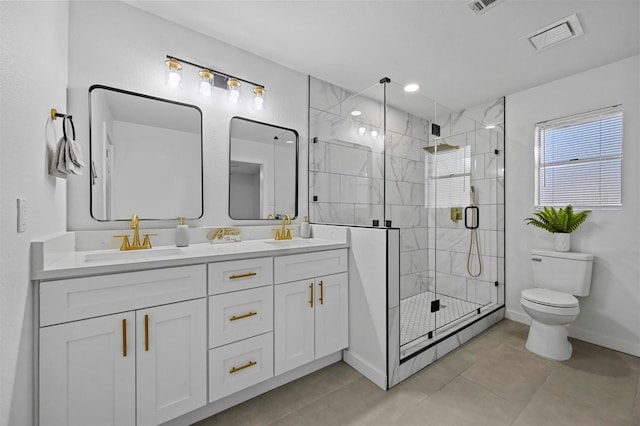 bathroom with vanity, tile patterned floors, toilet, and walk in shower