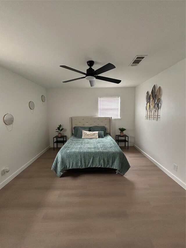 bedroom with wood-type flooring and ceiling fan