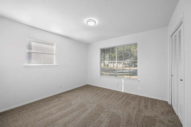 unfurnished bedroom with a closet and carpet flooring