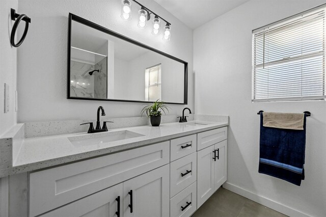 bathroom featuring vanity, a wealth of natural light, and walk in shower