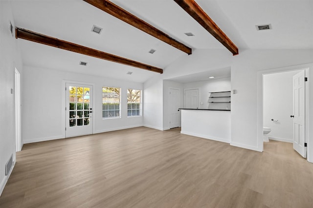 unfurnished living room featuring light hardwood / wood-style floors and vaulted ceiling with beams