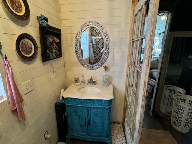 bathroom featuring wood walls and vanity