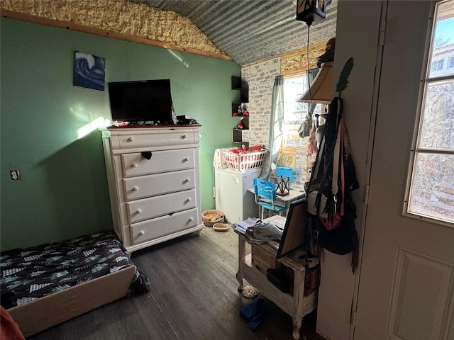 bedroom with lofted ceiling and dark wood finished floors