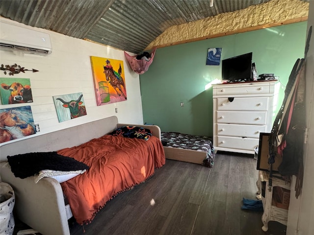 bedroom with lofted ceiling, dark wood finished floors, and a wall mounted air conditioner