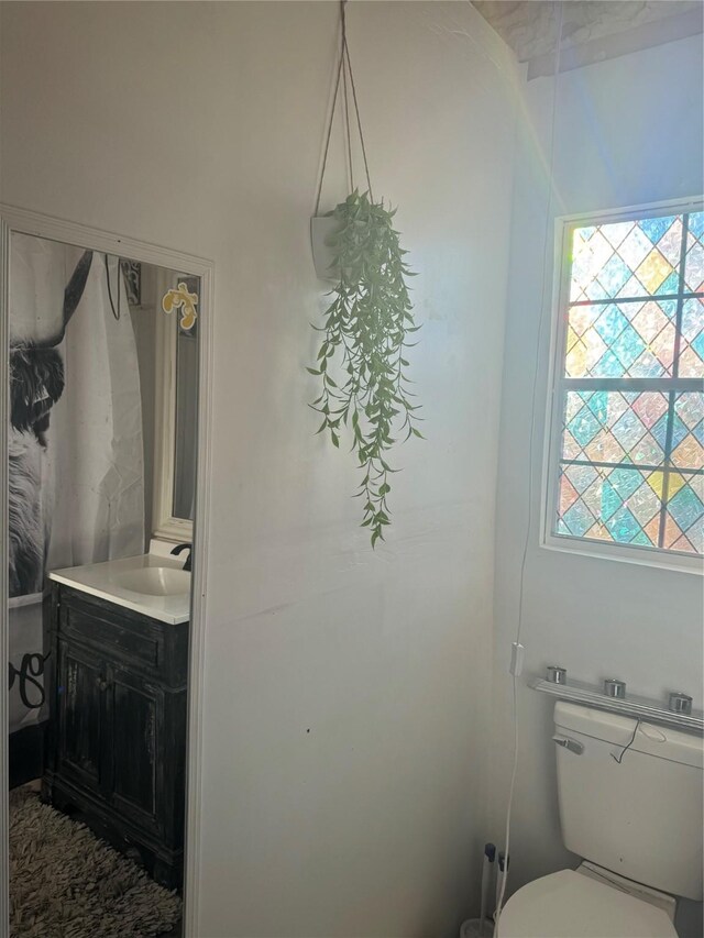 bathroom with a chandelier, lofted ceiling, toilet, a shower with shower door, and wood walls