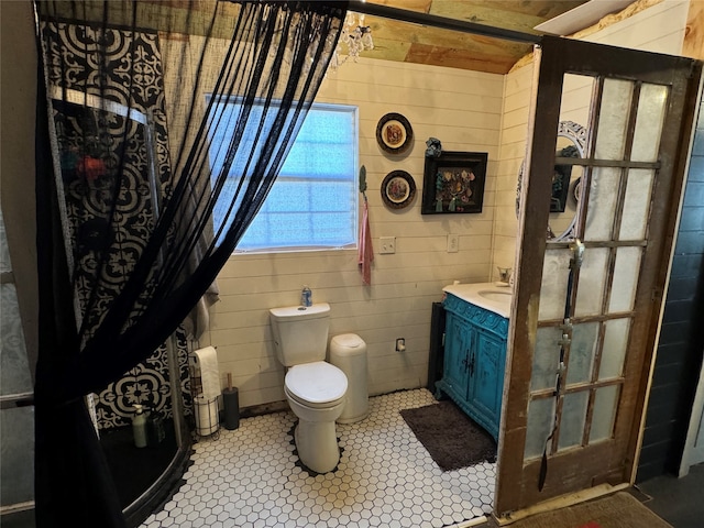 bathroom with tile patterned flooring, vanity, and toilet