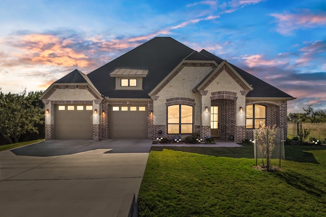 view of front of property with a lawn and a garage