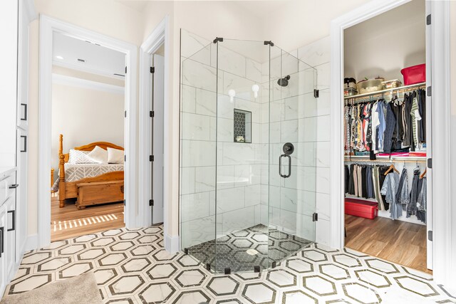 bathroom with hardwood / wood-style floors and walk in shower