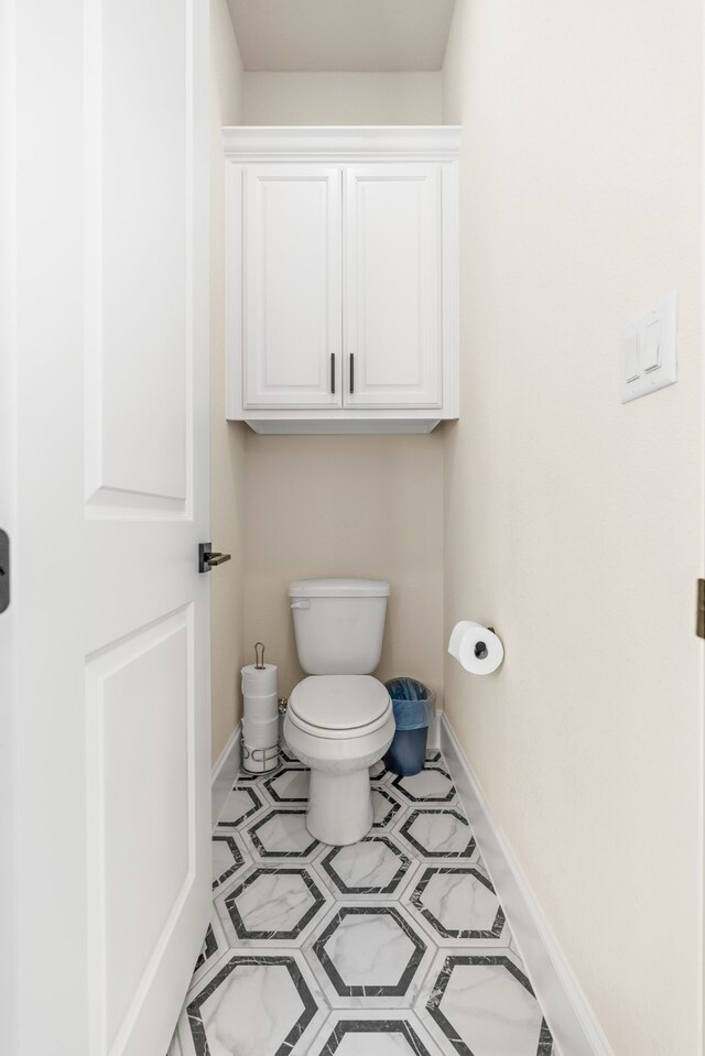 bathroom with tile patterned flooring and toilet