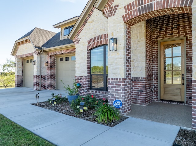 view of exterior entry with a garage