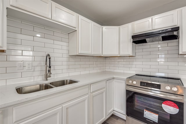 kitchen featuring stainless steel stove, white cabinetry, and sink