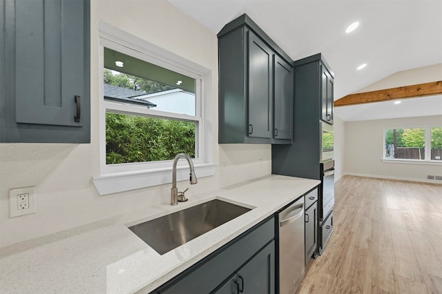 kitchen with gray cabinetry, sink, vaulted ceiling with beams, light wood-type flooring, and stainless steel appliances