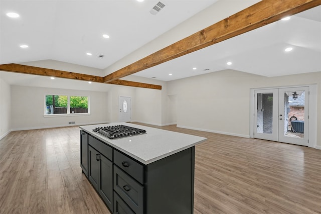 kitchen featuring lofted ceiling with beams, french doors, light hardwood / wood-style floors, and stainless steel gas stovetop