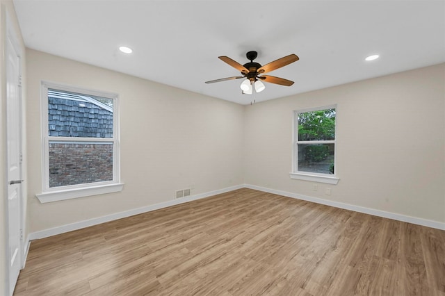 empty room featuring ceiling fan and light hardwood / wood-style floors