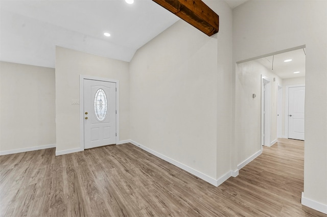 entryway featuring lofted ceiling with beams and light hardwood / wood-style floors