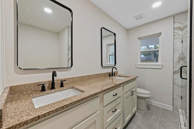 bathroom featuring vanity, toilet, and a shower with door