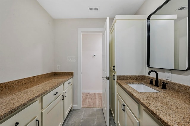 bathroom with tile patterned floors and vanity