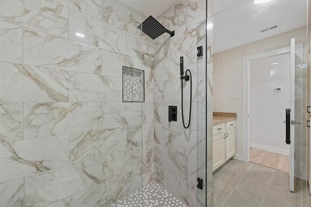 bathroom with vanity and a shower with shower door