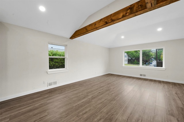 empty room with vaulted ceiling with beams, plenty of natural light, and dark wood-type flooring