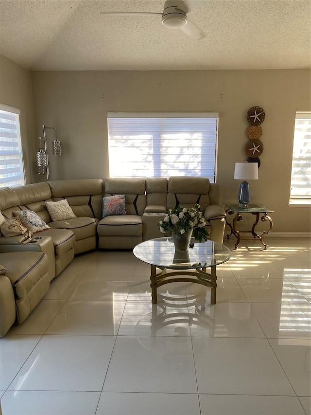 tiled living room featuring a textured ceiling, plenty of natural light, and ceiling fan