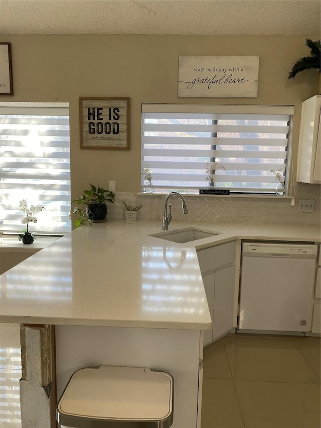 710 Cresent Dr, Desoto, TX 75115 - kitchen with dishwasher, white cabinets, light countertops, plenty of natural light, and a textured ceiling