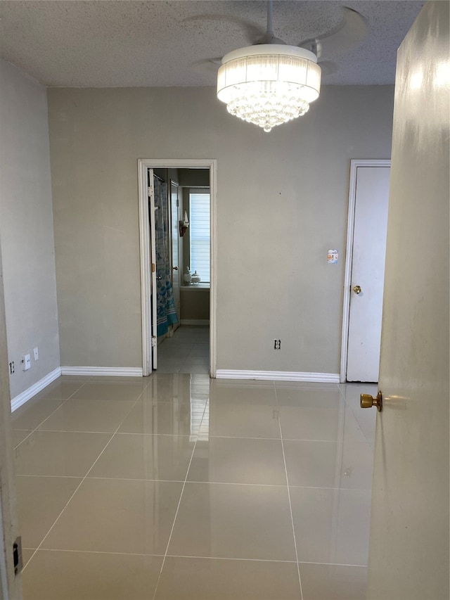 empty room with tile patterned flooring and a textured ceiling