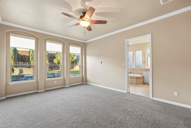 carpeted spare room featuring ceiling fan and ornamental molding