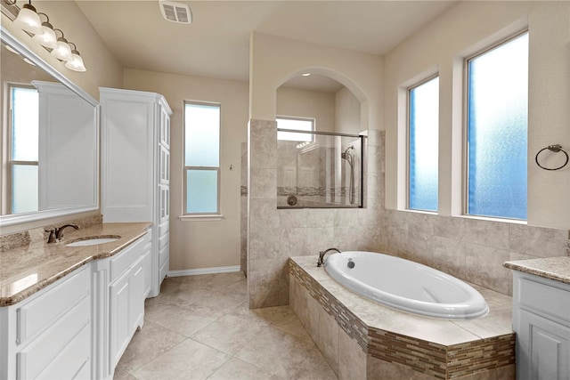 bathroom featuring tile patterned flooring, vanity, and independent shower and bath