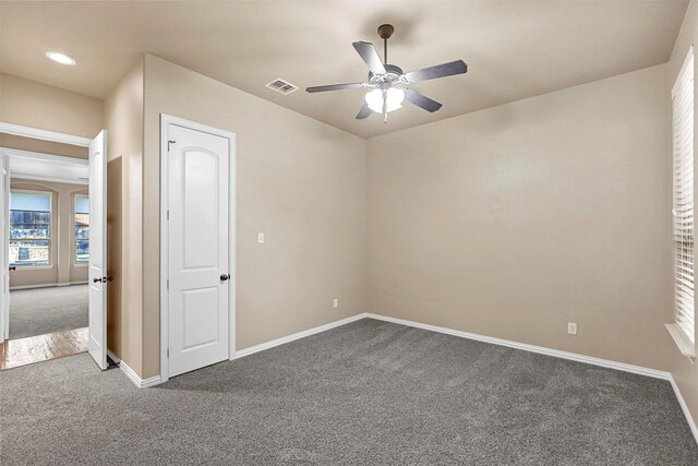 empty room with carpet flooring and ceiling fan