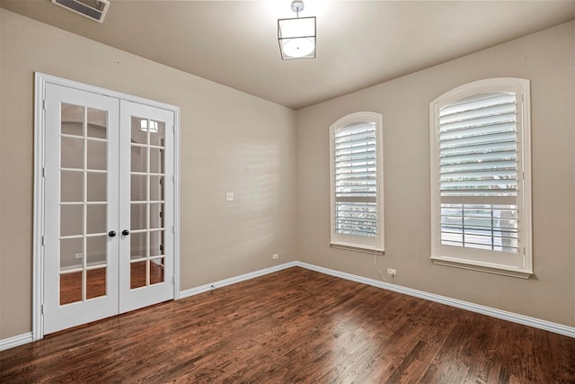 empty room featuring french doors, dark hardwood / wood-style floors, and a wealth of natural light