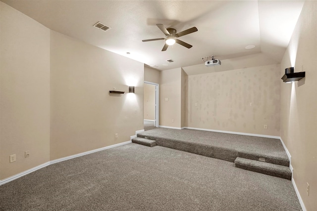 home theater featuring carpet, ceiling fan, and vaulted ceiling