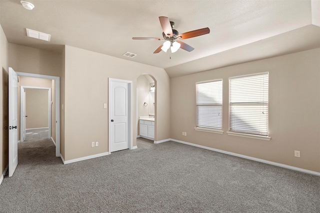 unfurnished bedroom featuring carpet flooring, ensuite bath, and ceiling fan