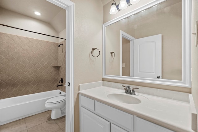 full bathroom featuring vanity, tile patterned floors, tiled shower / bath combo, and toilet